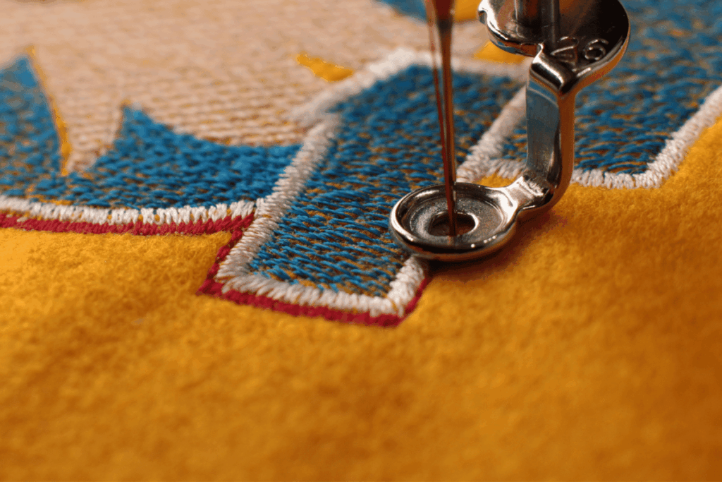 A close-up of a t-shirt being embroidered