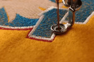 A close-up of a t-shirt being embroidered